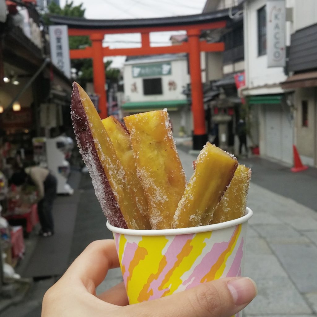 Snacking on Japanese yam fries at a stand near Fushimi Inari